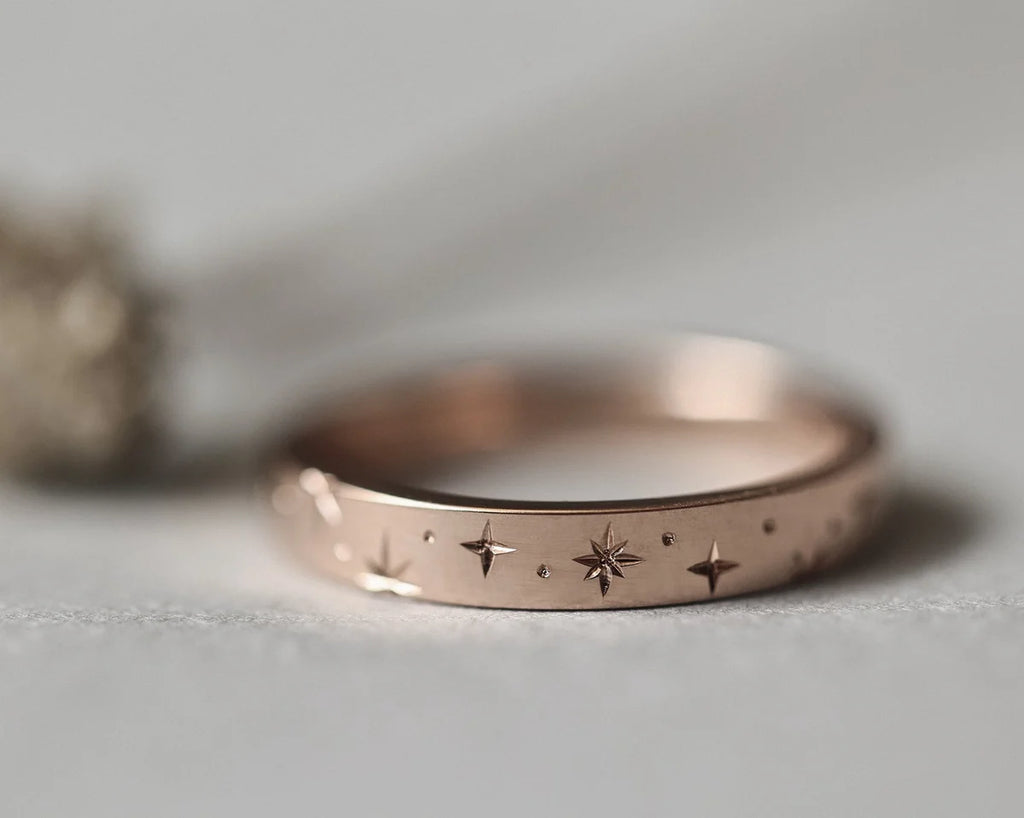 star engraving setting detail rose gold wedding ring