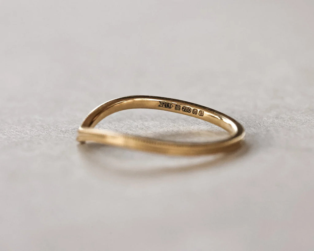 Gold ring on a light gray background