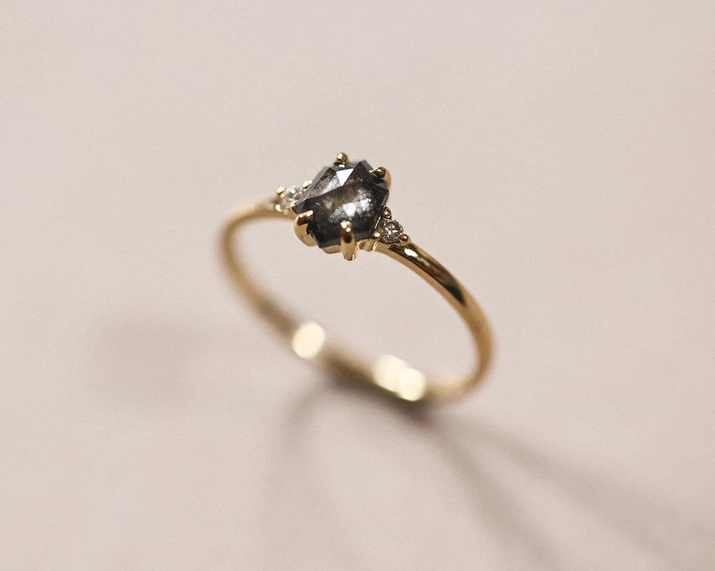Side view of the 18ct yellow gold grey diamond trilogy ring