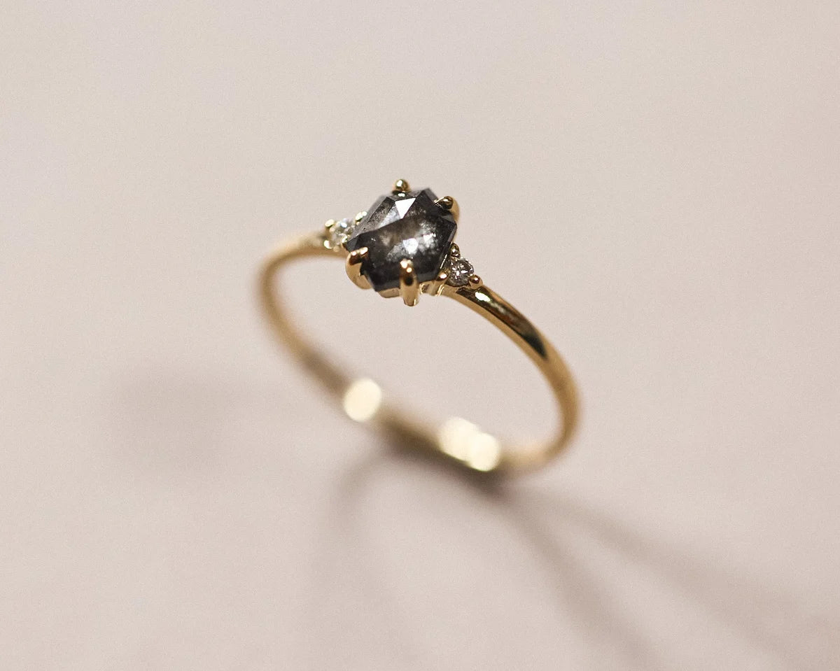 Side view of the 18ct yellow gold grey diamond trilogy ring