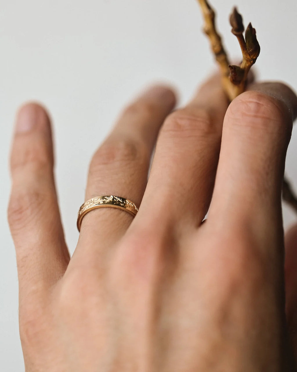 Fir engraved wedding ring worn on hand in 9ct yellow gold
