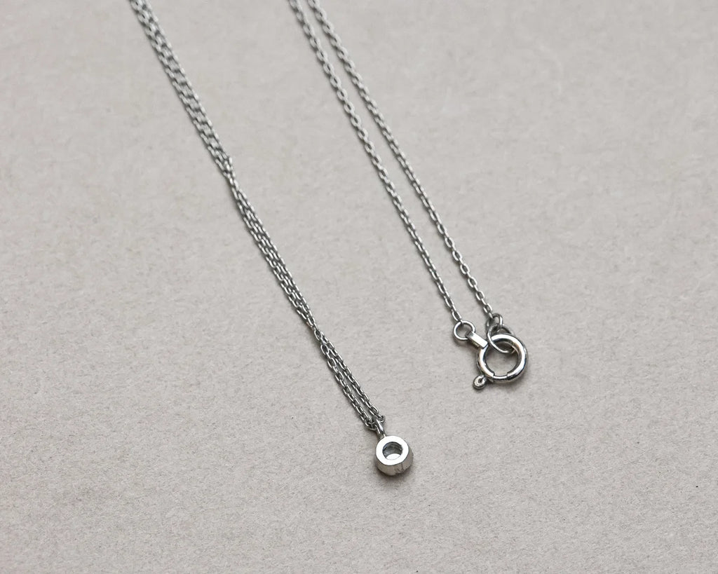 thin chain platinum necklace close up detail