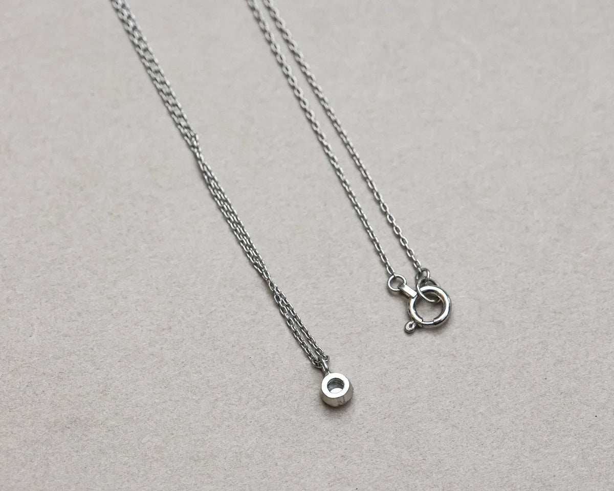 thin chain platinum necklace close up detail