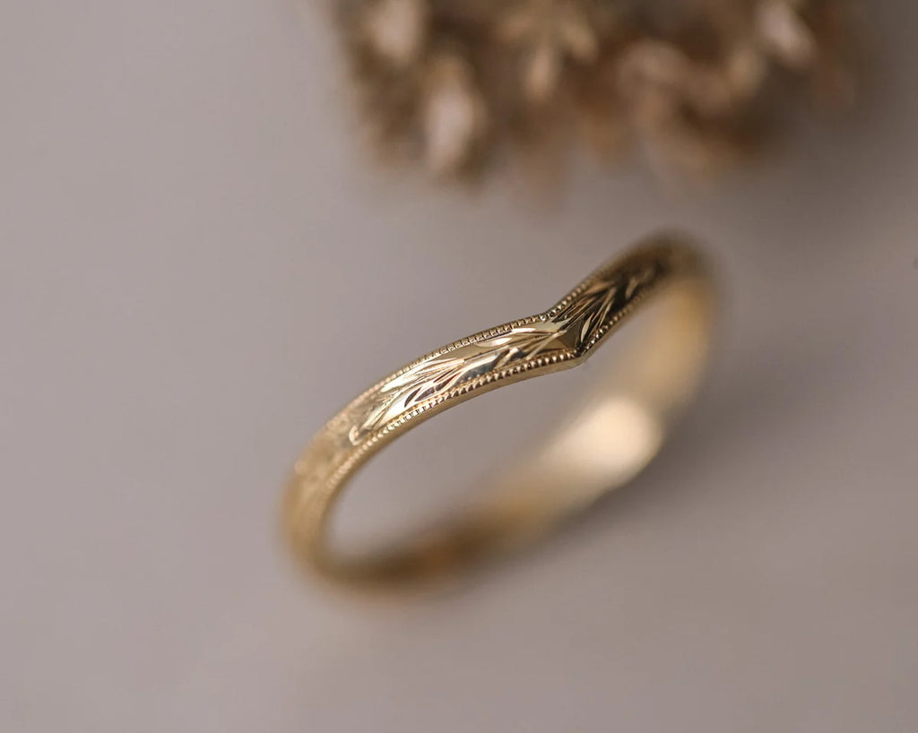 Angled view of 18ct yellow gold olive leaf wishbone wedding ring