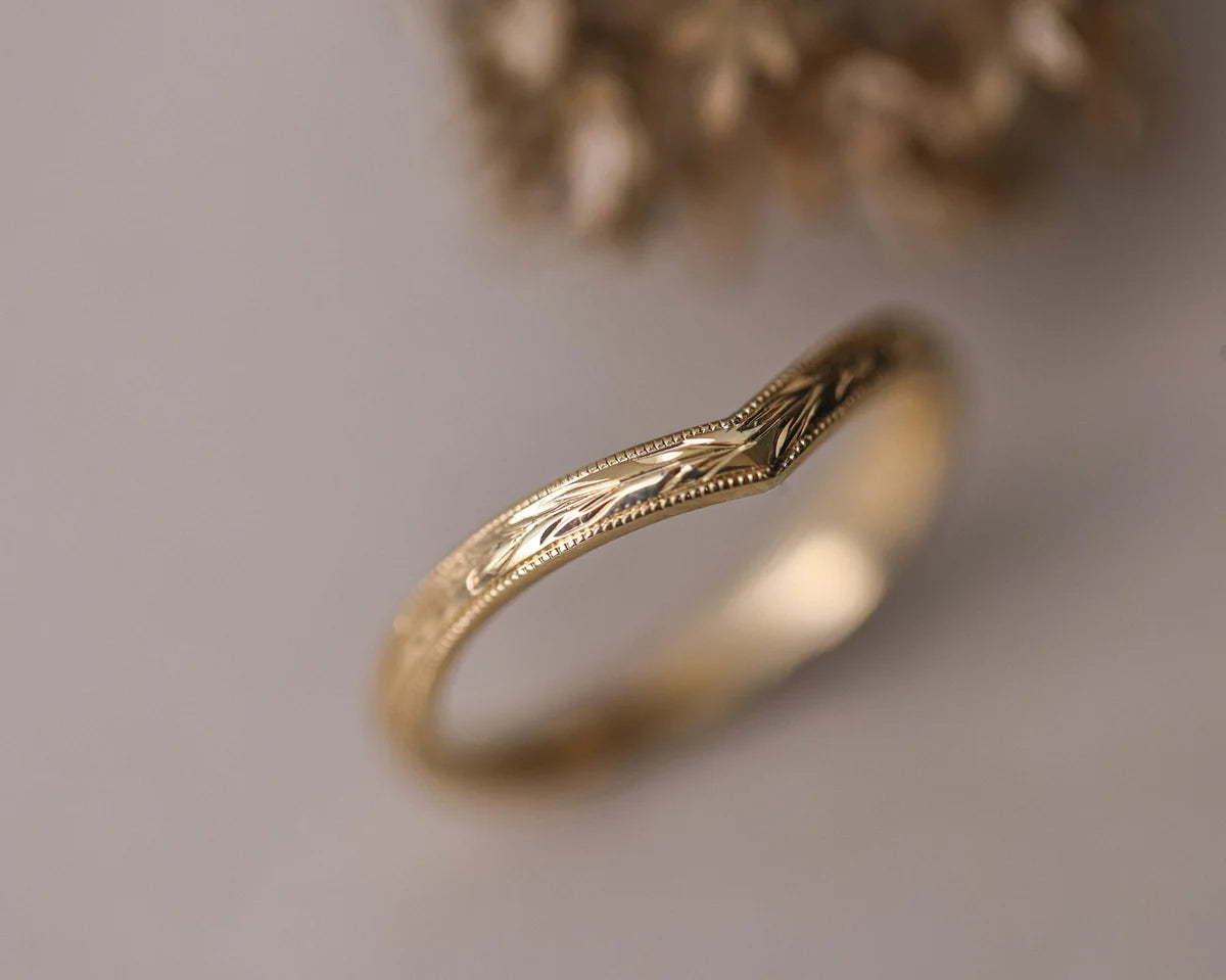 Angled view of 18ct yellow gold olive leaf wishbone wedding ring