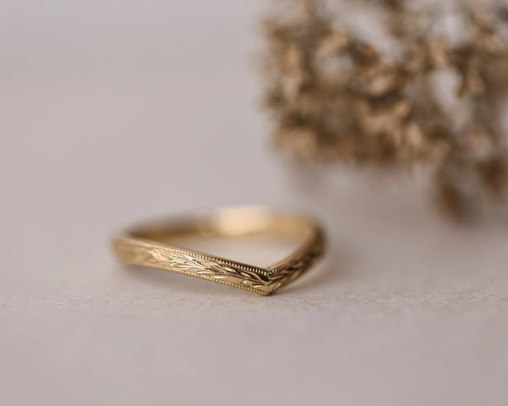 Front view of 2mm yellow gold wishbone ring with olive leaf engraving