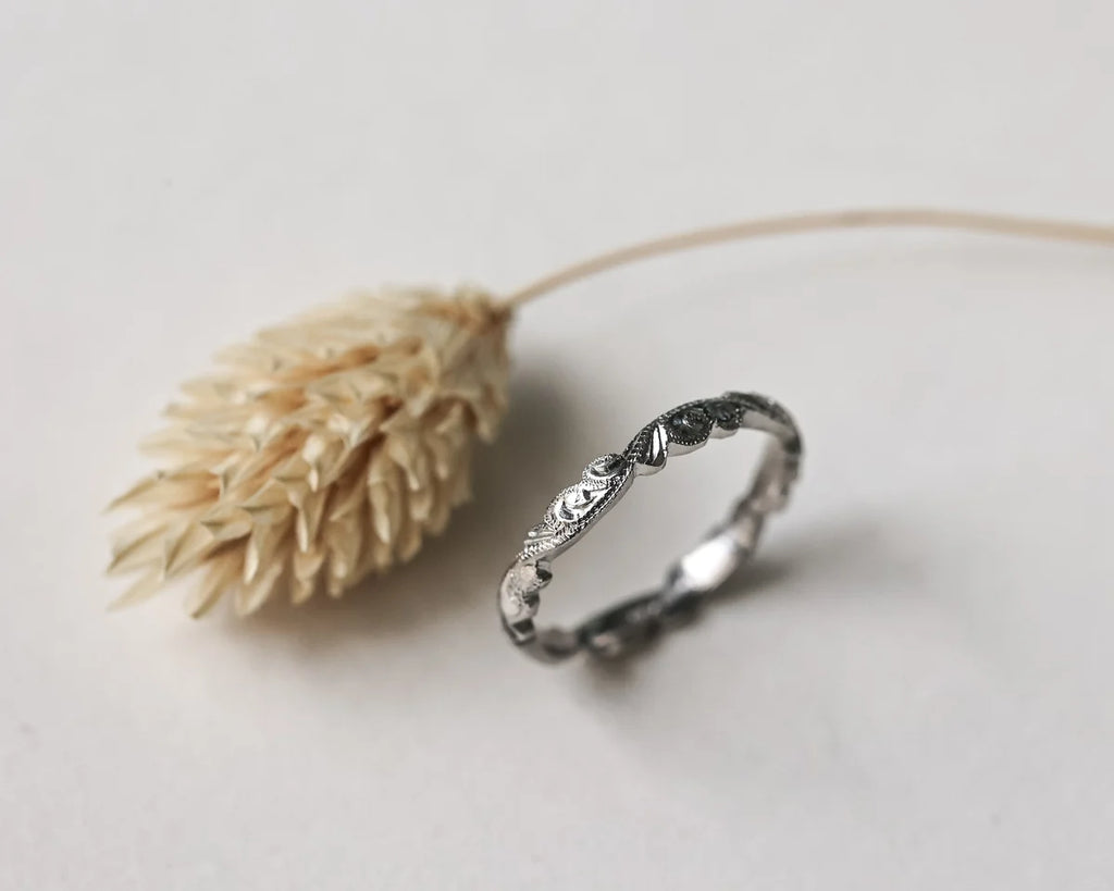 Side view of handmade floral carved ring in platinum