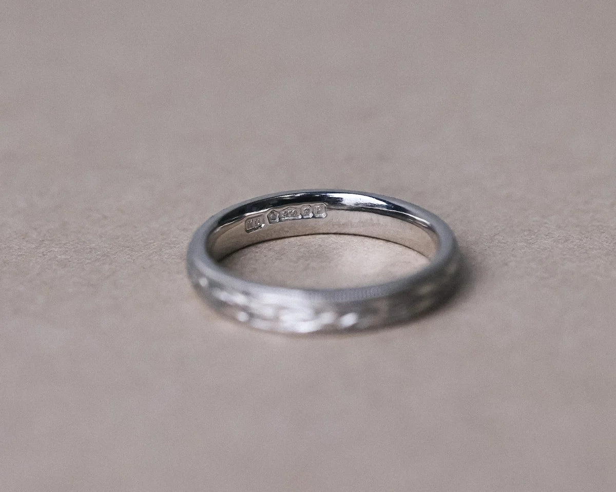 Minimal platinum olive leaf and milled edge wedding ring
