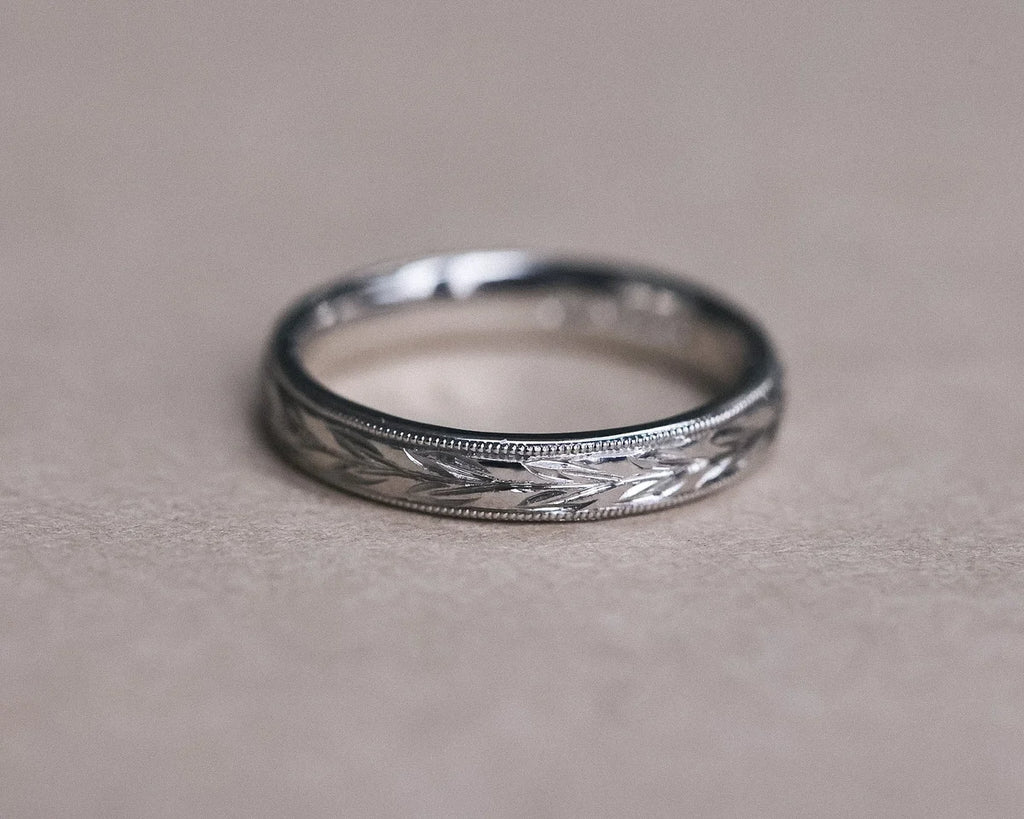 Detailed view of handmade olive leaf engraved ring in platinum