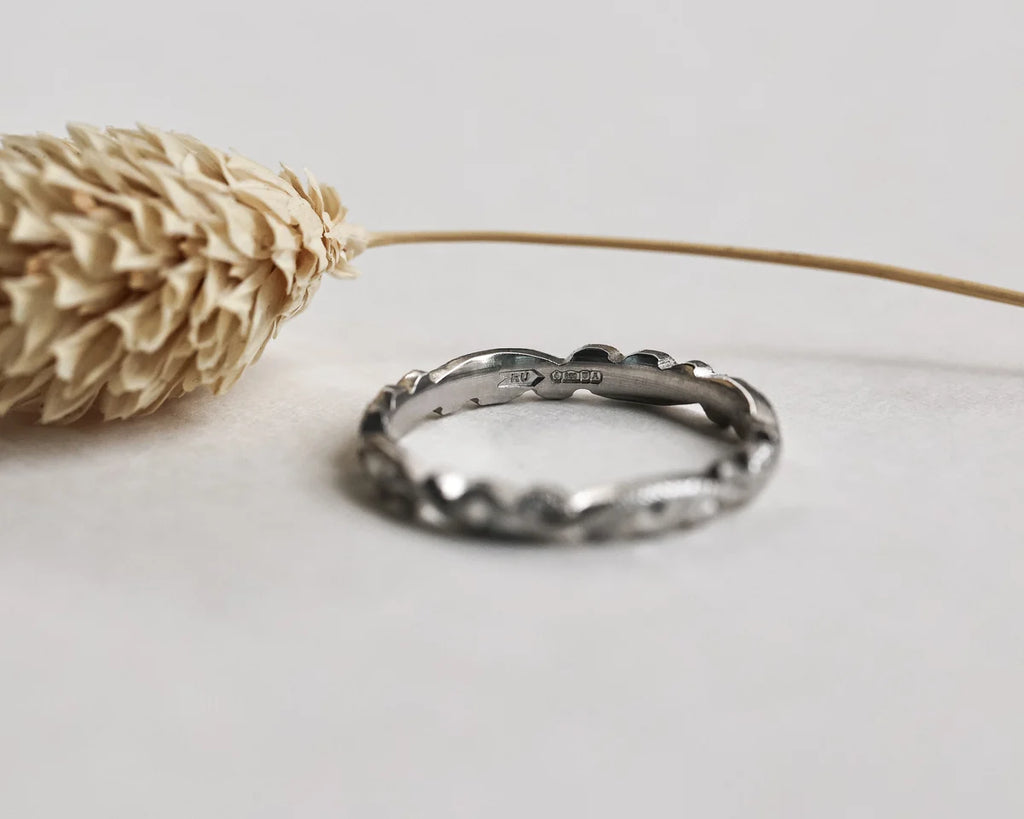 Low front view of platinum floral carved wedding ring