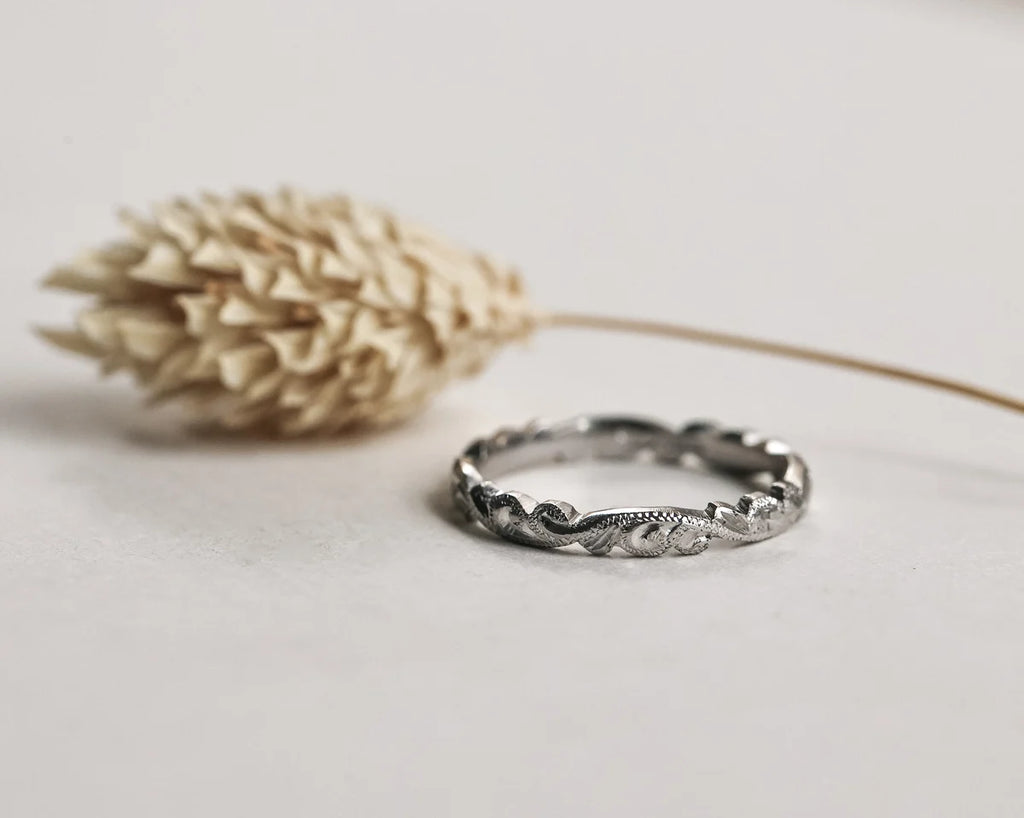 Front view of 2.5mm platinum floral carved wedding band