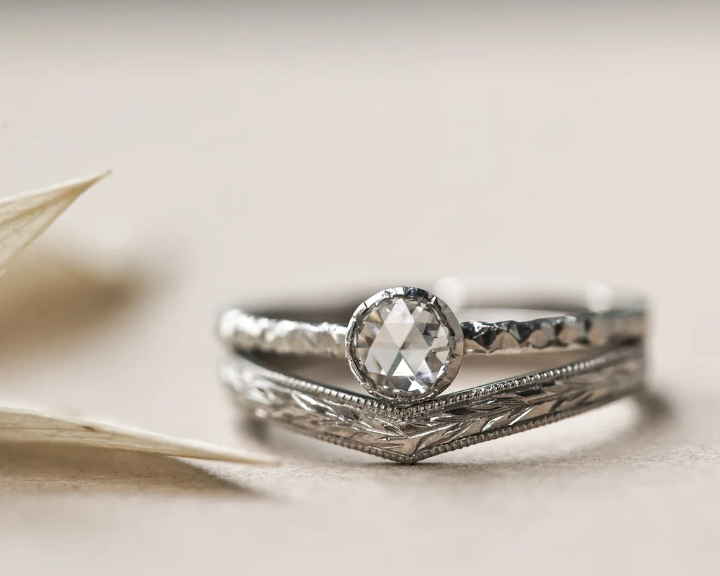 Platinum olive leaf wishbone ring stacked with rose-cut diamond engagement ring