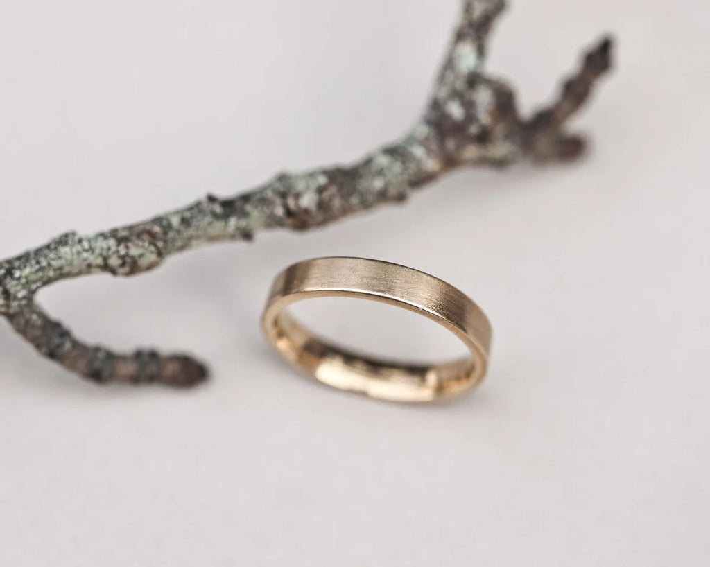 brushed matte texture gold band wedding ring detail
