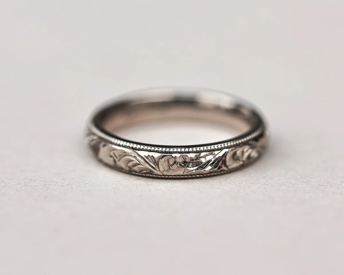 Low front view of 18ct white gold floral engraved wedding ring