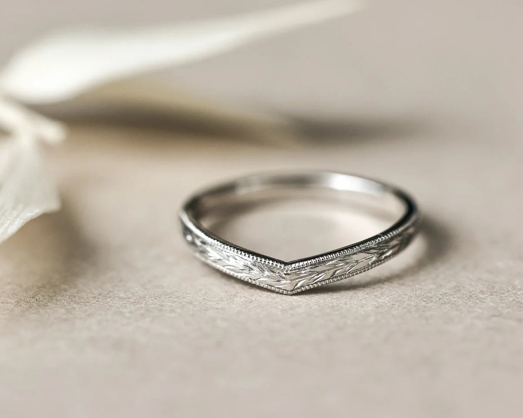 Platinum olive leaf wishbone wedding ring styled with pale leaves