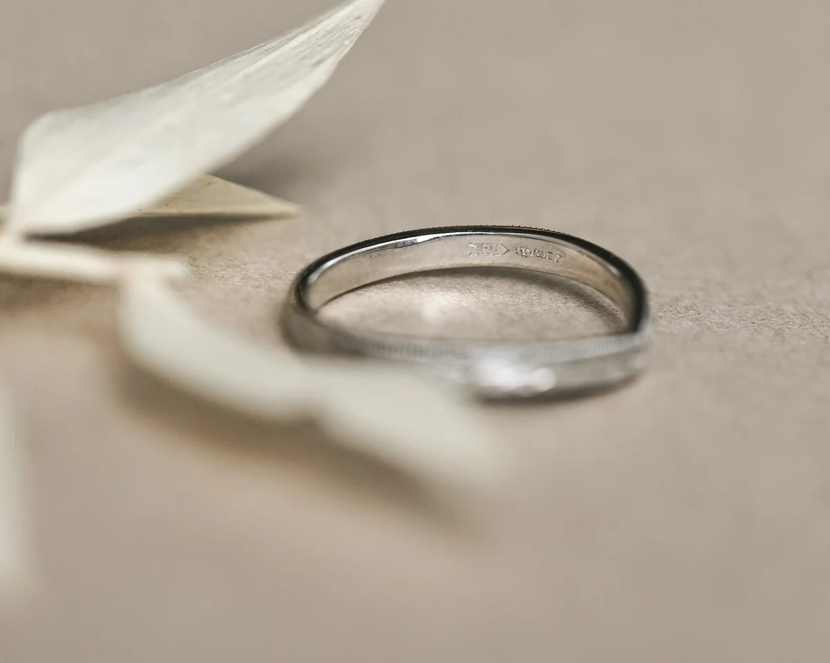 Side profile of platinum wishbone ring with olive leaf engraving