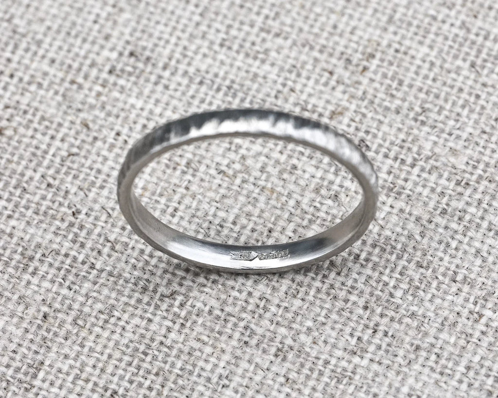 Silver ring on a textured fabric background