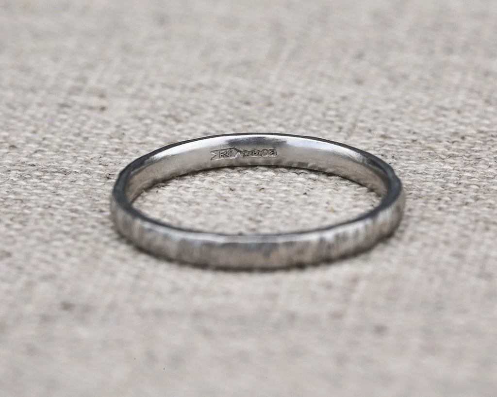 Silver ring on a textured gray surface