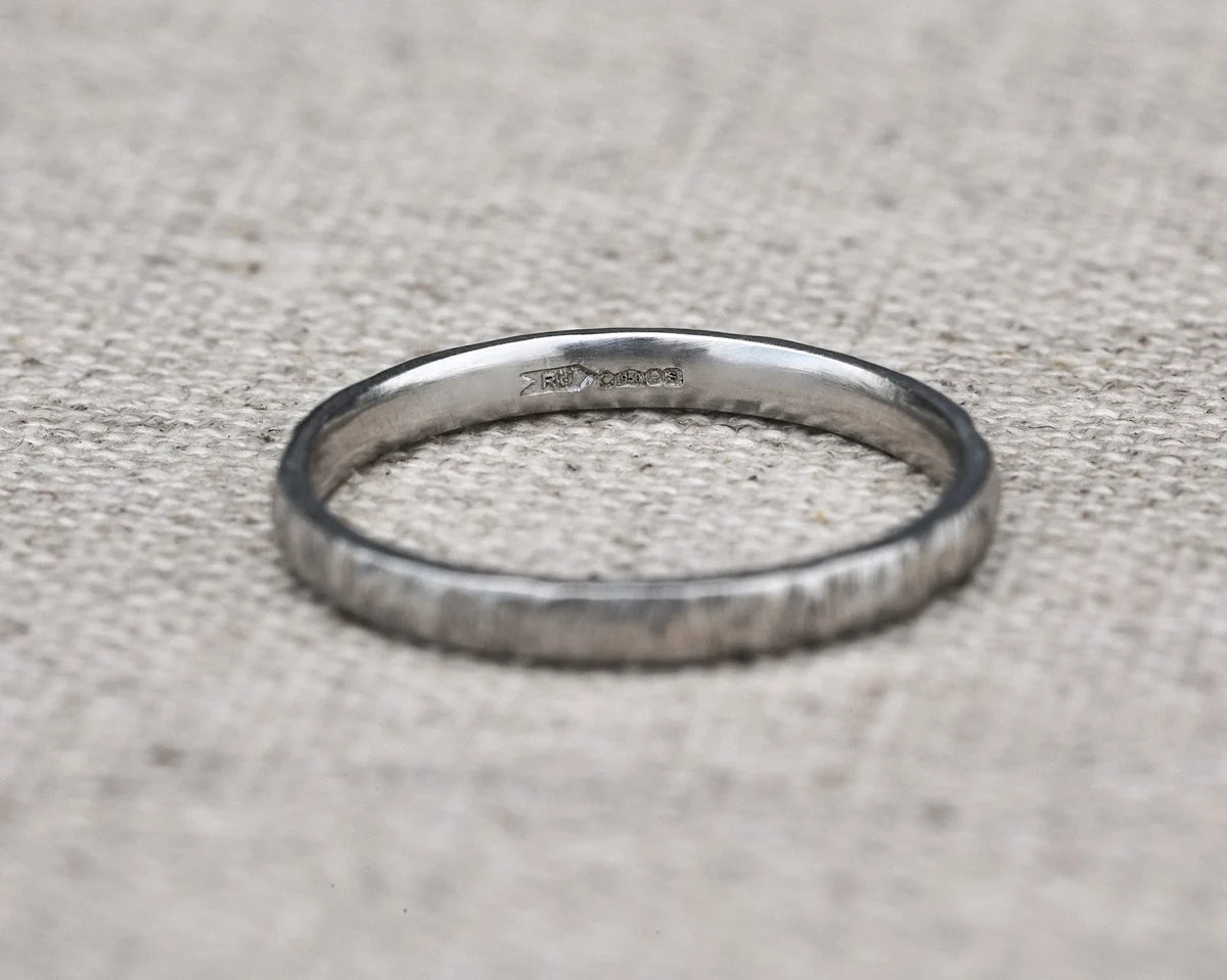 Silver ring on a textured gray surface
