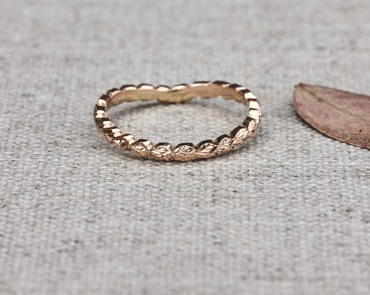 close up laurel leaf carving detail on 2mm rose gold wishbone ring