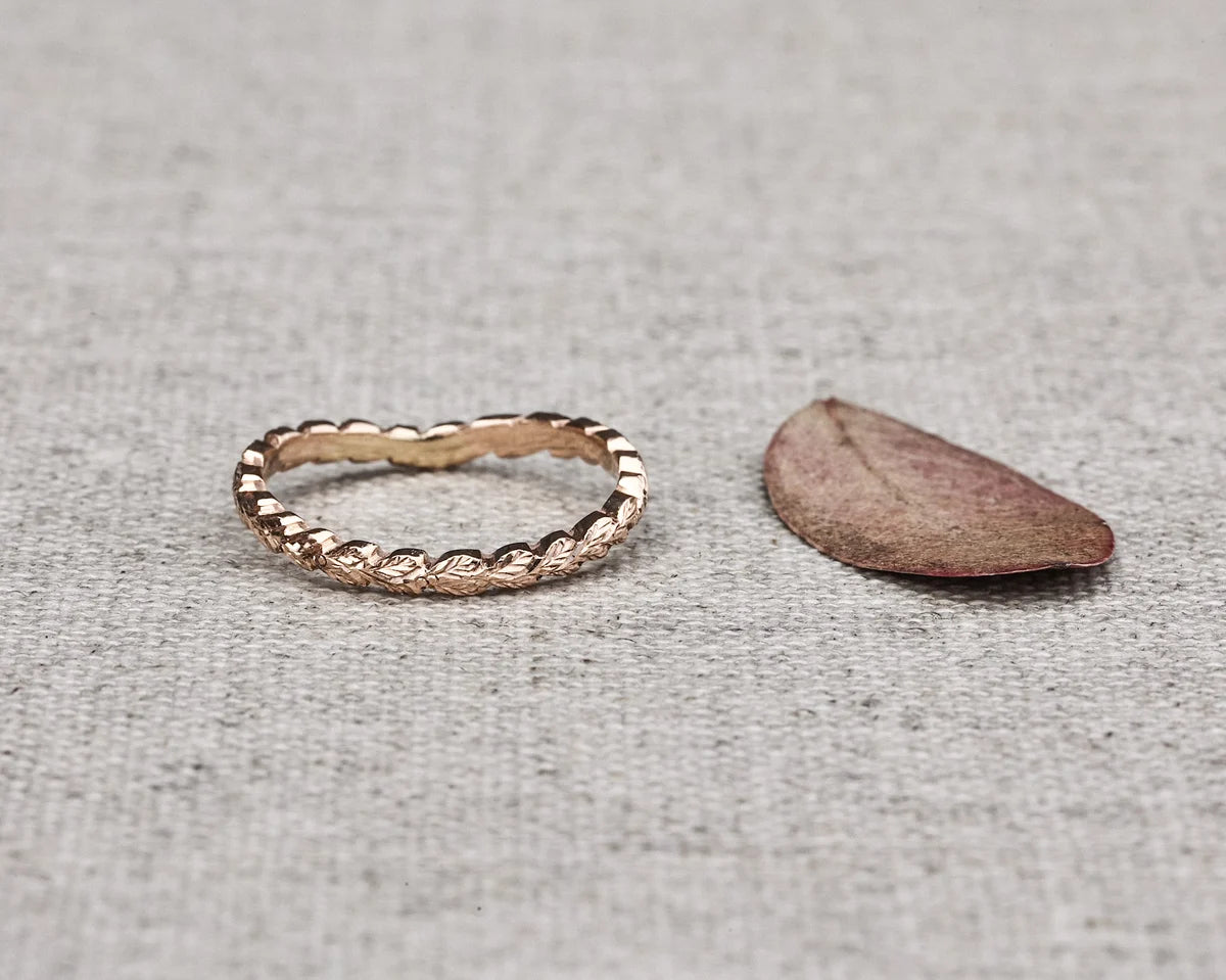 close up laurel leaf carving detail on 2mm rose gold wishbone ring
