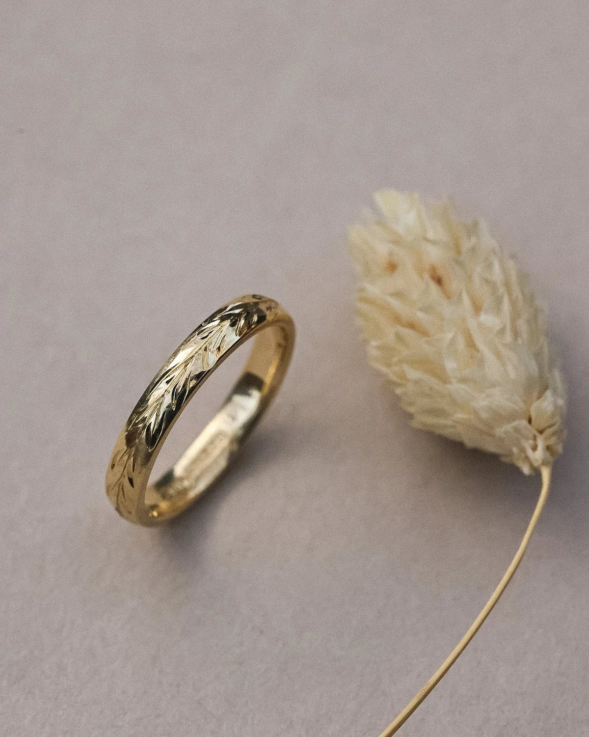 Vertical view of yellow gold olive leaf ring with botanical styling