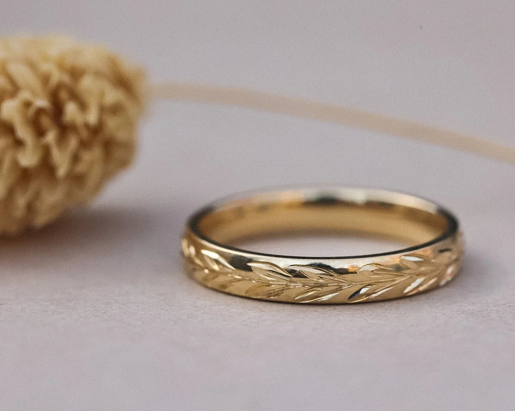 Front view of 3mm yellow gold wedding band with olive leaf engraving