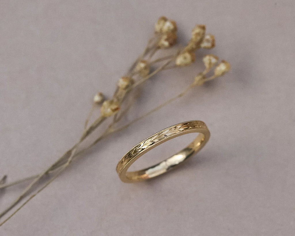 18ct yellow gold olive leaf and milled edge ring with botanical styling