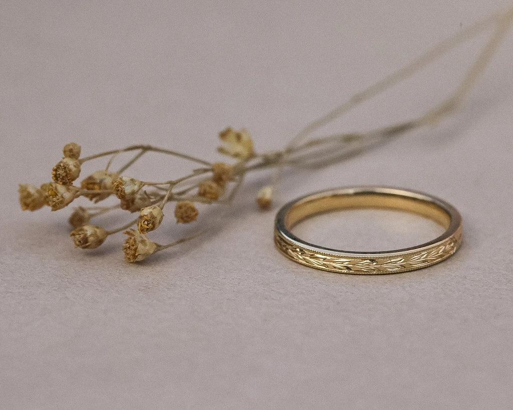 Minimal 2mm olive leaf wedding ring in yellow gold with dried flowers