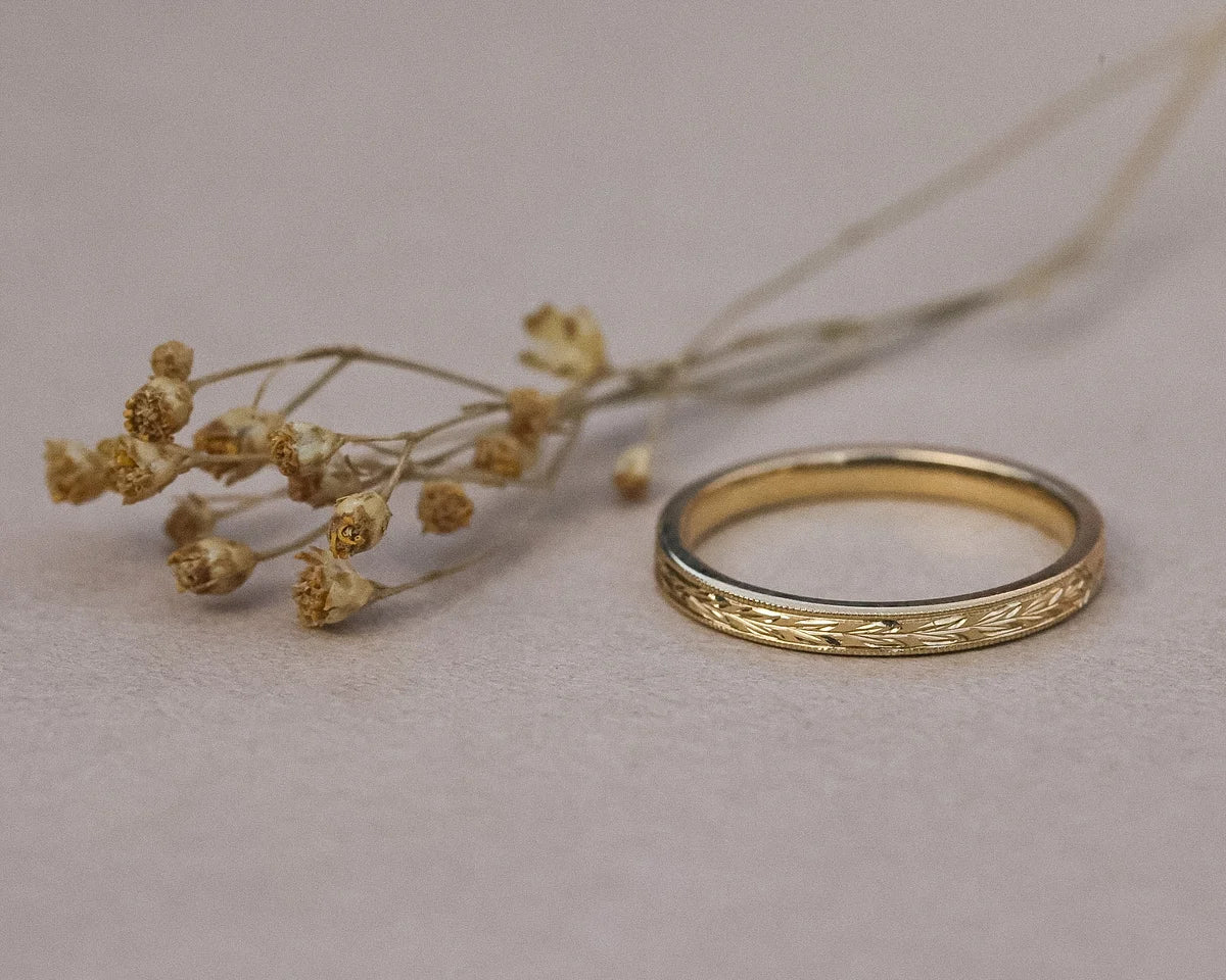 Minimal 2mm olive leaf wedding ring in yellow gold with dried flowers