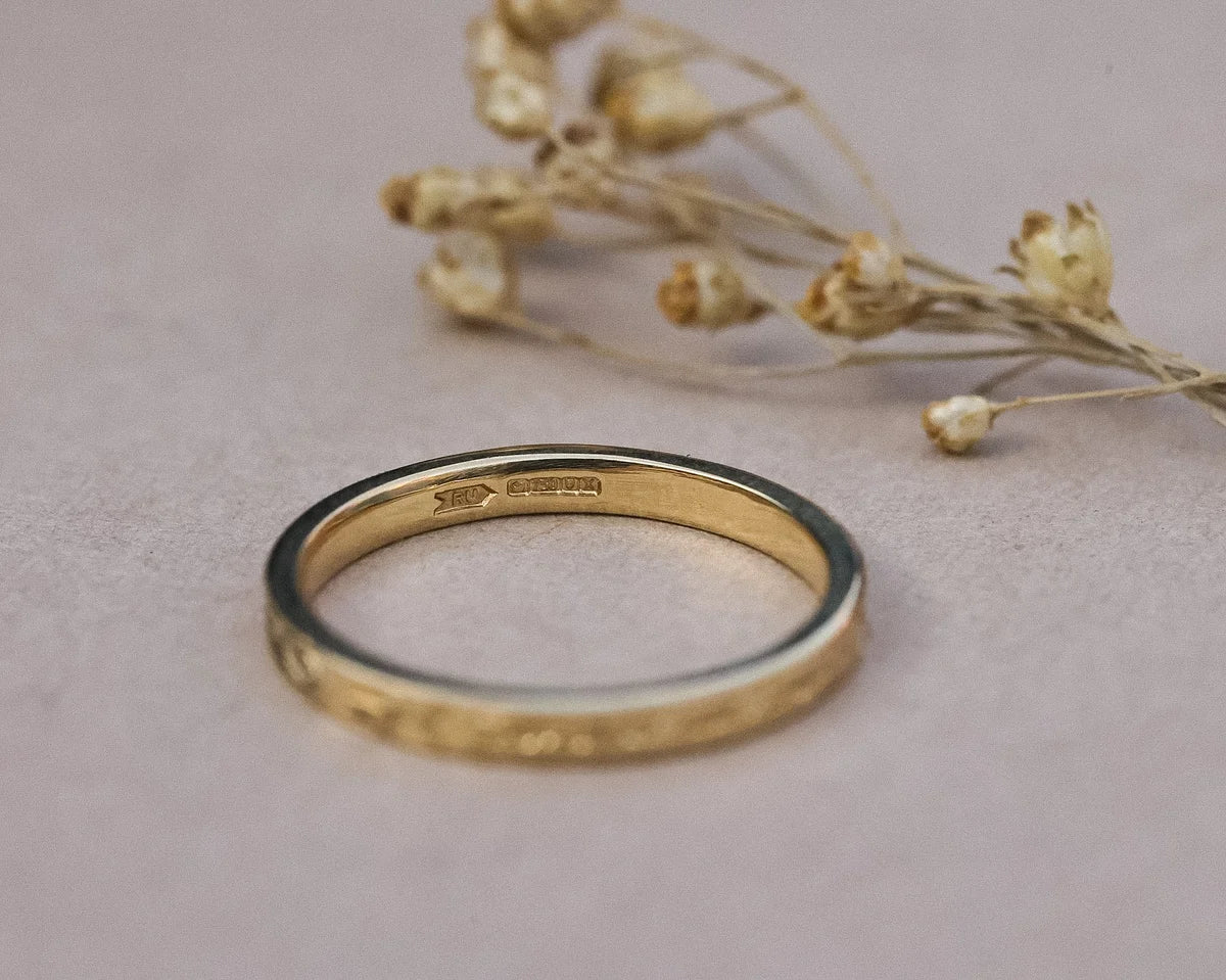 Inside view of 18ct yellow gold wedding ring with hallmark