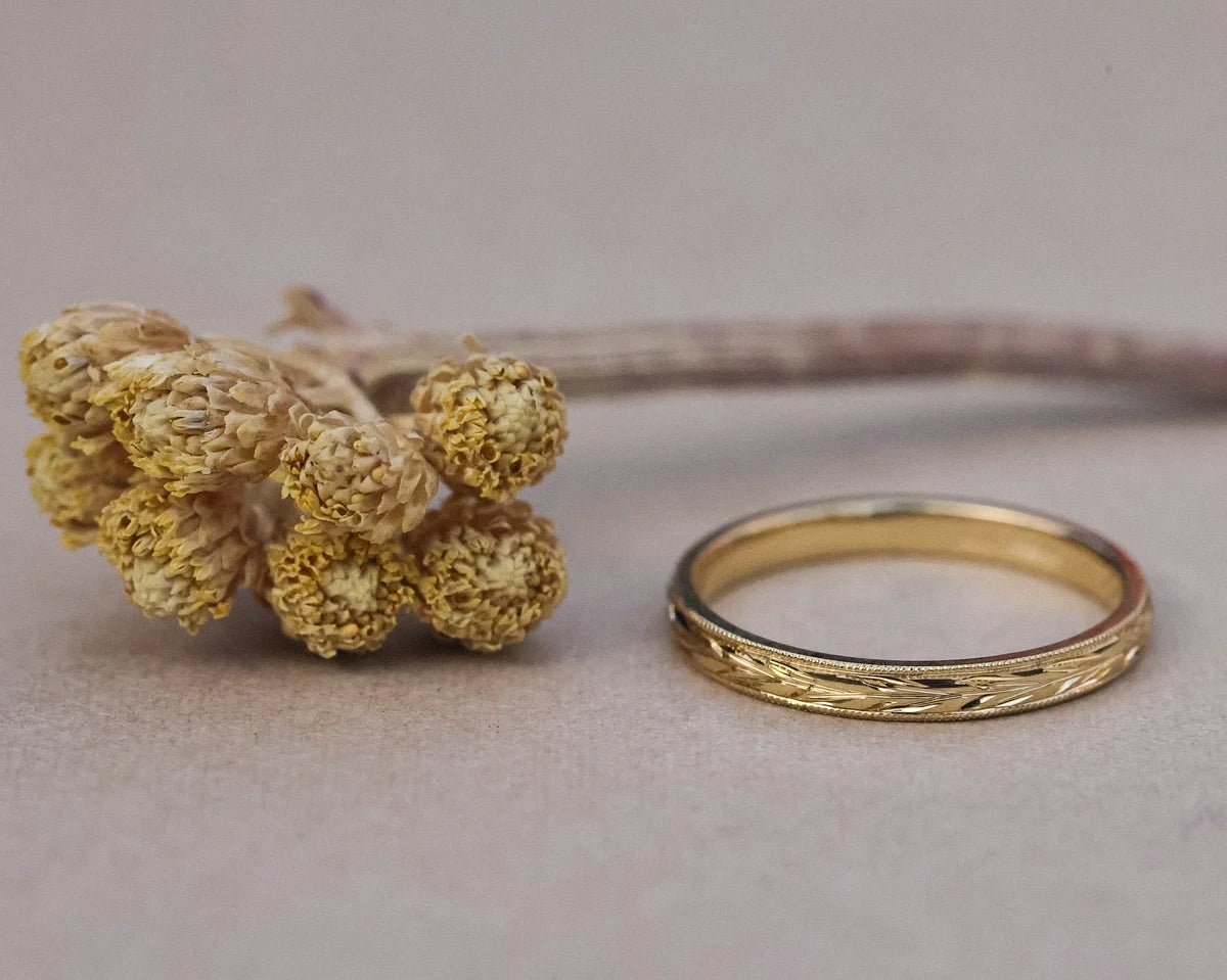 Front view of olive leaf engraved wedding ring in 18ct yellow gold