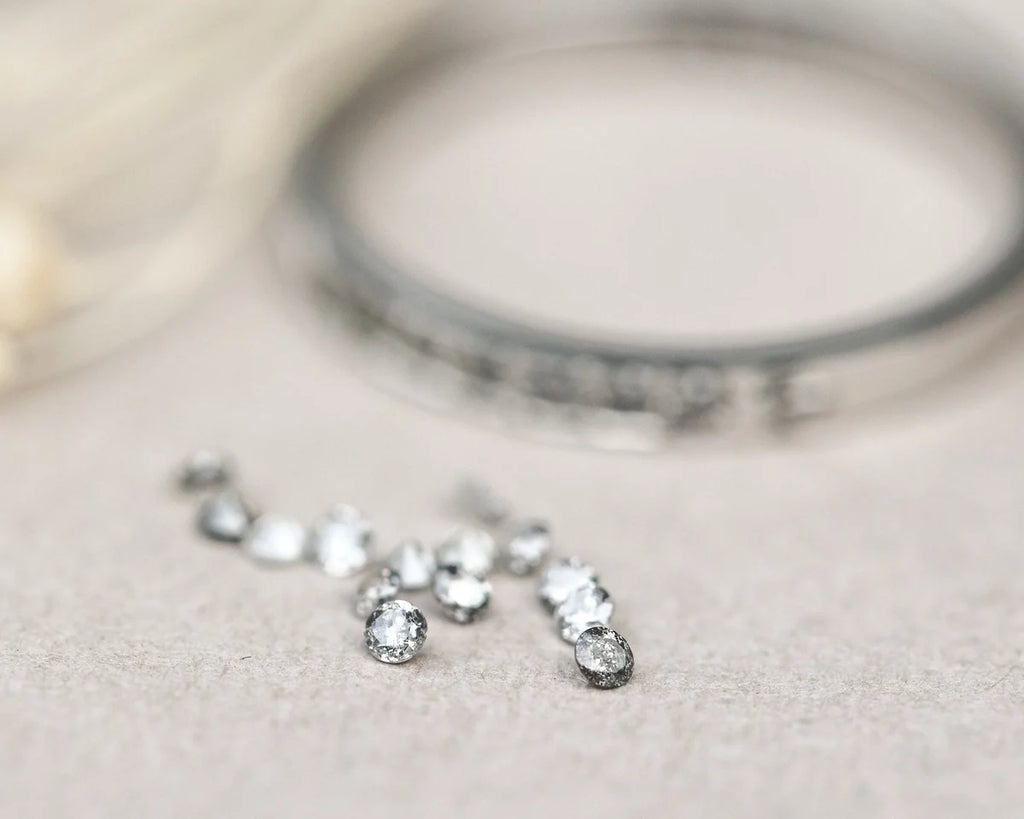 Silver bracelet with small round stones on a light background