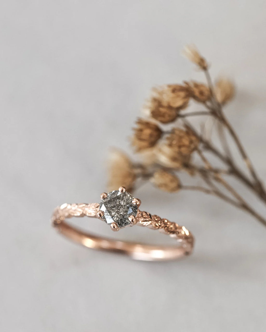 rose gold ring with grey diamond and engraved leaf band
