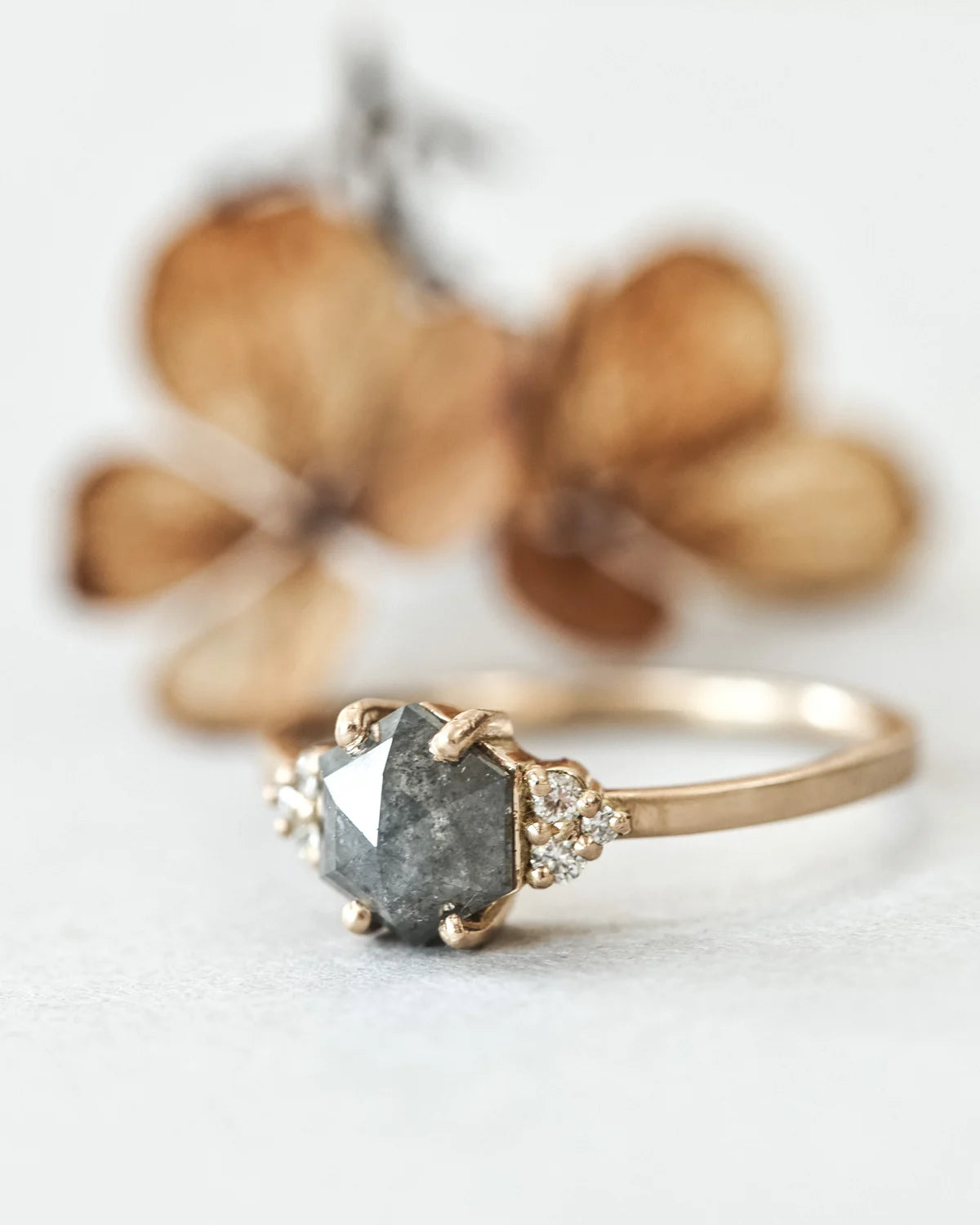 Angled view of 18ct yellow gold dark grey diamond ring