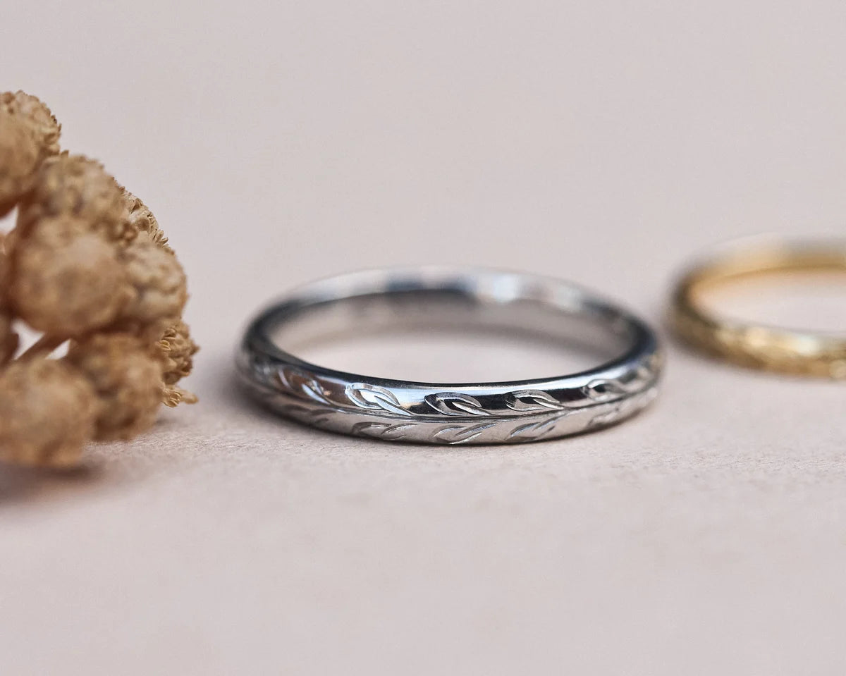 Platinum olive leaf engraved wedding ring paired with yellow gold band