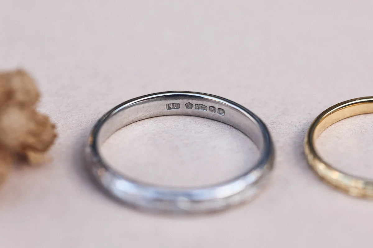 Inside view of platinum olive leaf wedding ring with hallmark