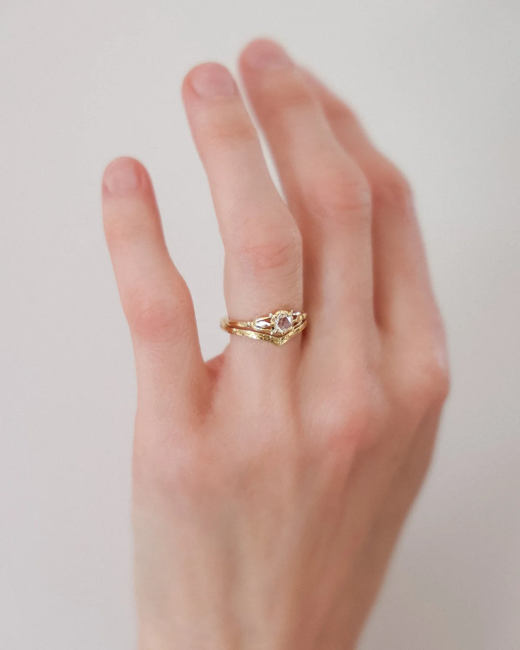 Close-up of the Fleur de Lys diamond ring worn on the finger