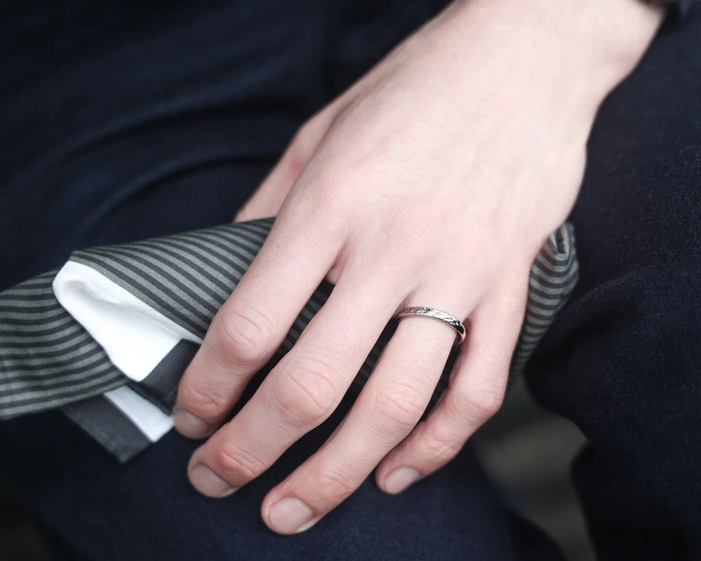 Barleycorn engraved white gold wedding ring worn on hand