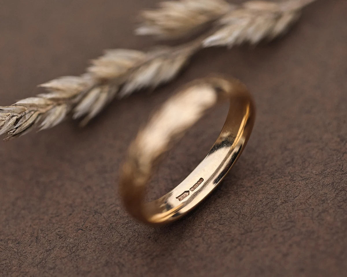 Inside view of 9ct yellow gold court wedding ring with hallmark