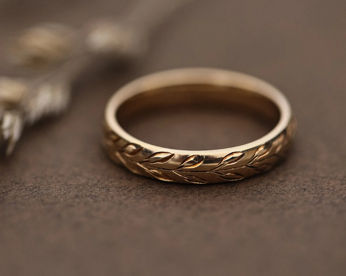 Detailed view of olive leaf engraving on 9ct yellow gold band