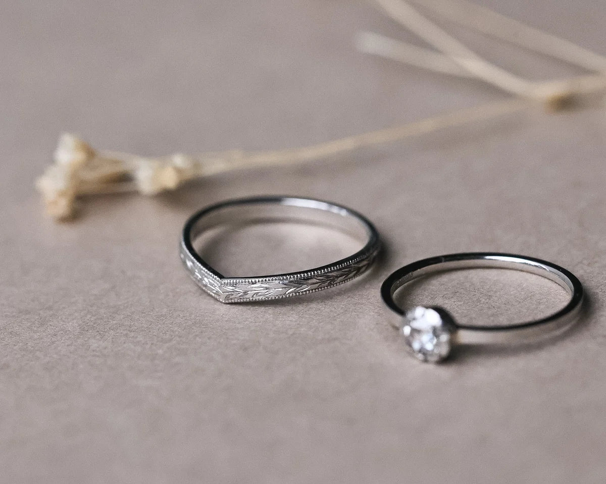 Platinum wishbone wedding ring paired with diamond engagement ring