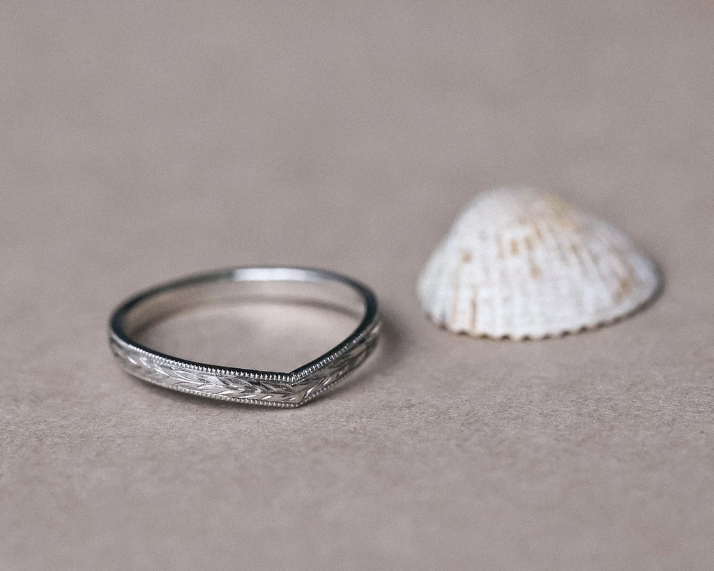 Platinum wishbone wedding ring with olive leaf engraving and shell styling