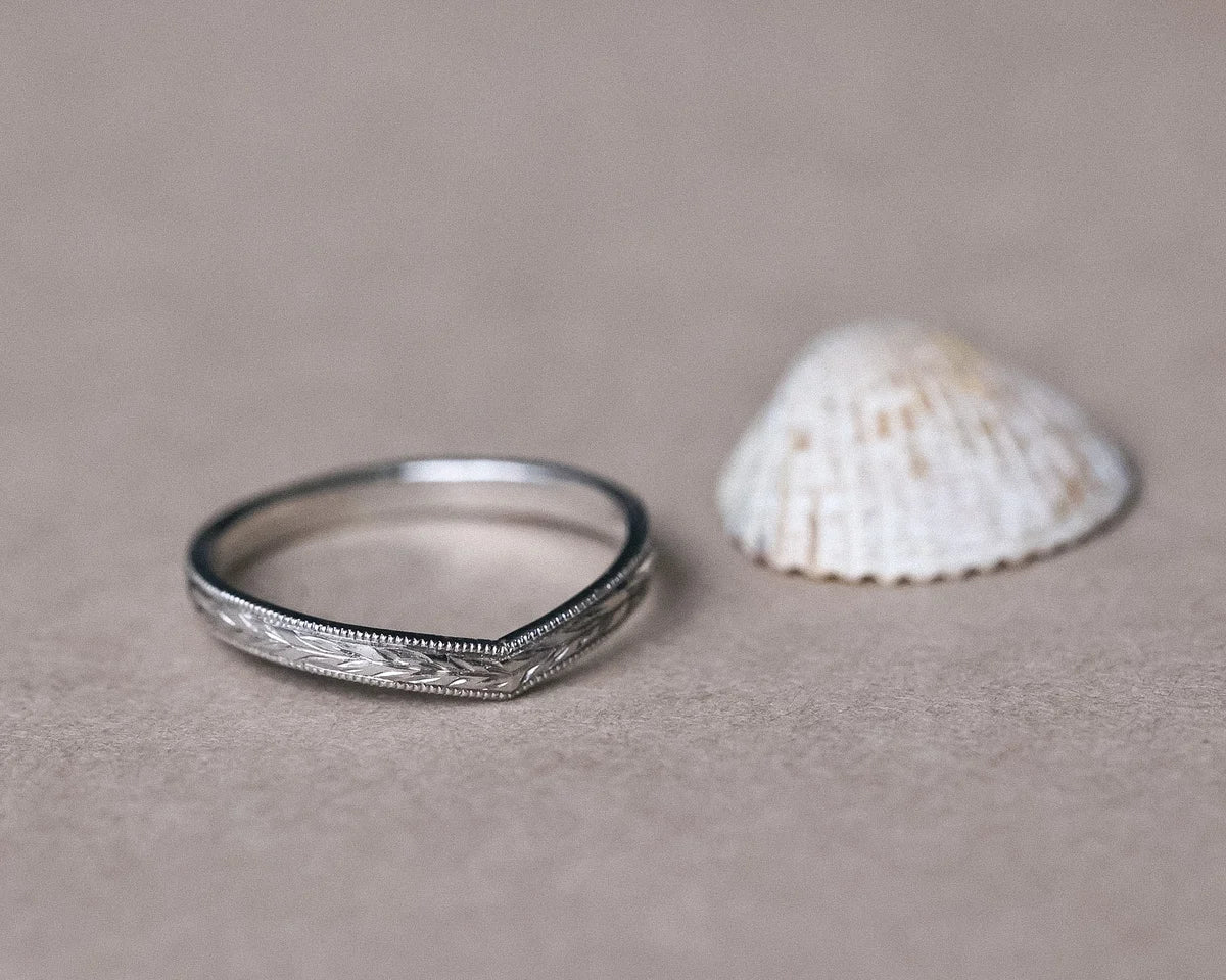 Platinum wishbone wedding ring with olive leaf engraving and shell styling