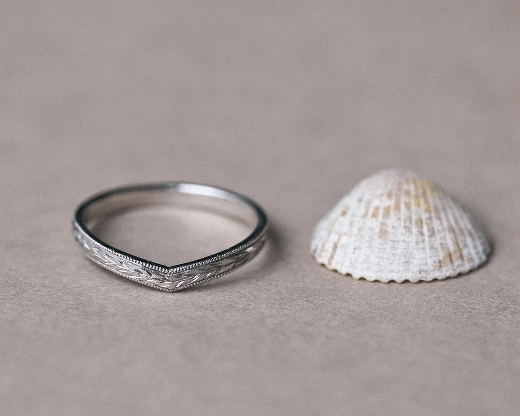 Low front view of platinum wishbone wedding band with olive leaf detail