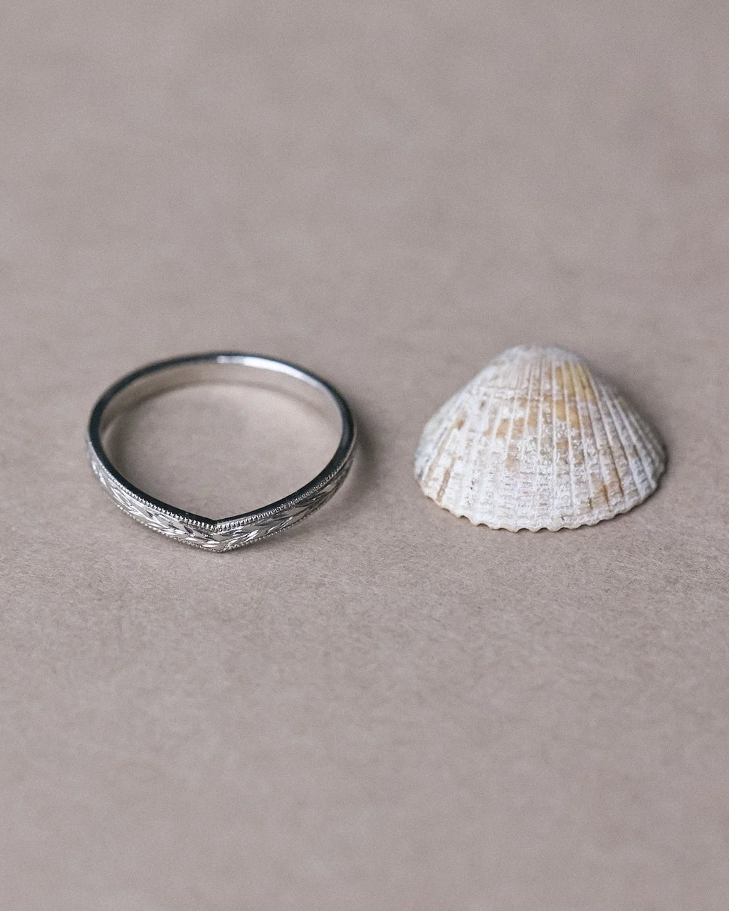 Minimal platinum olive leaf wishbone ring styled with seashell