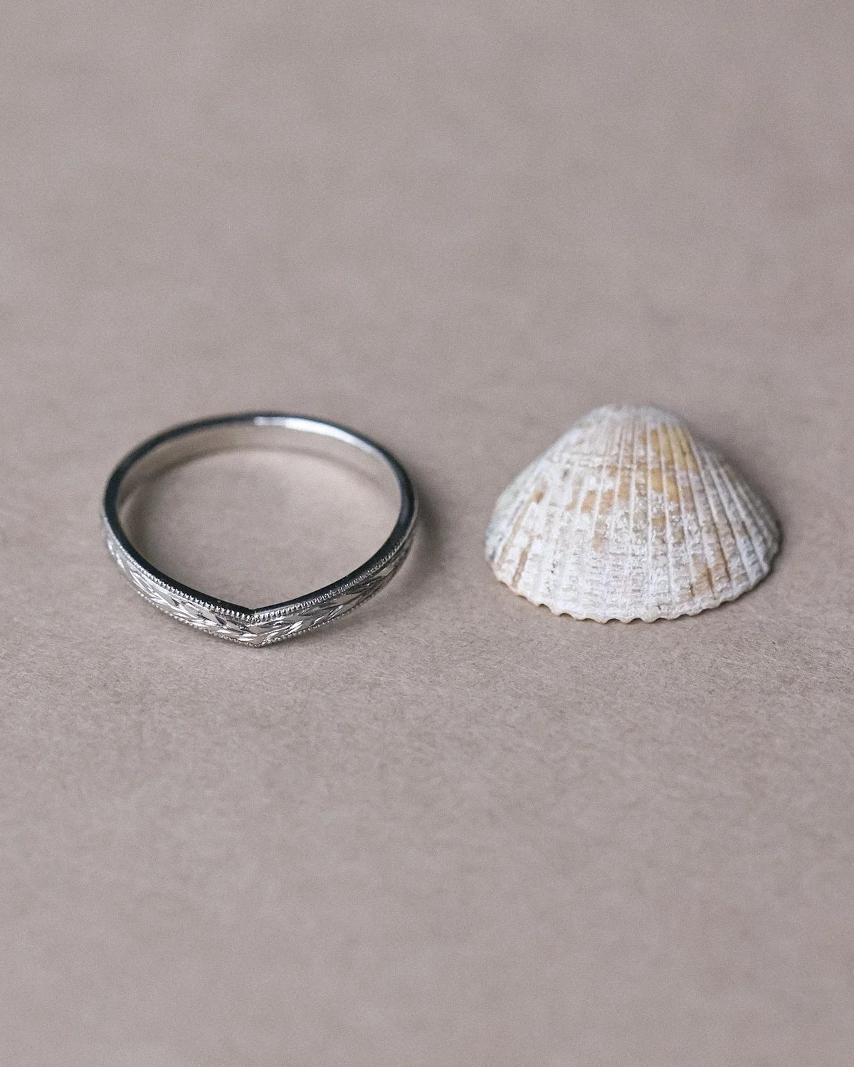Minimal platinum olive leaf wishbone ring styled with seashell