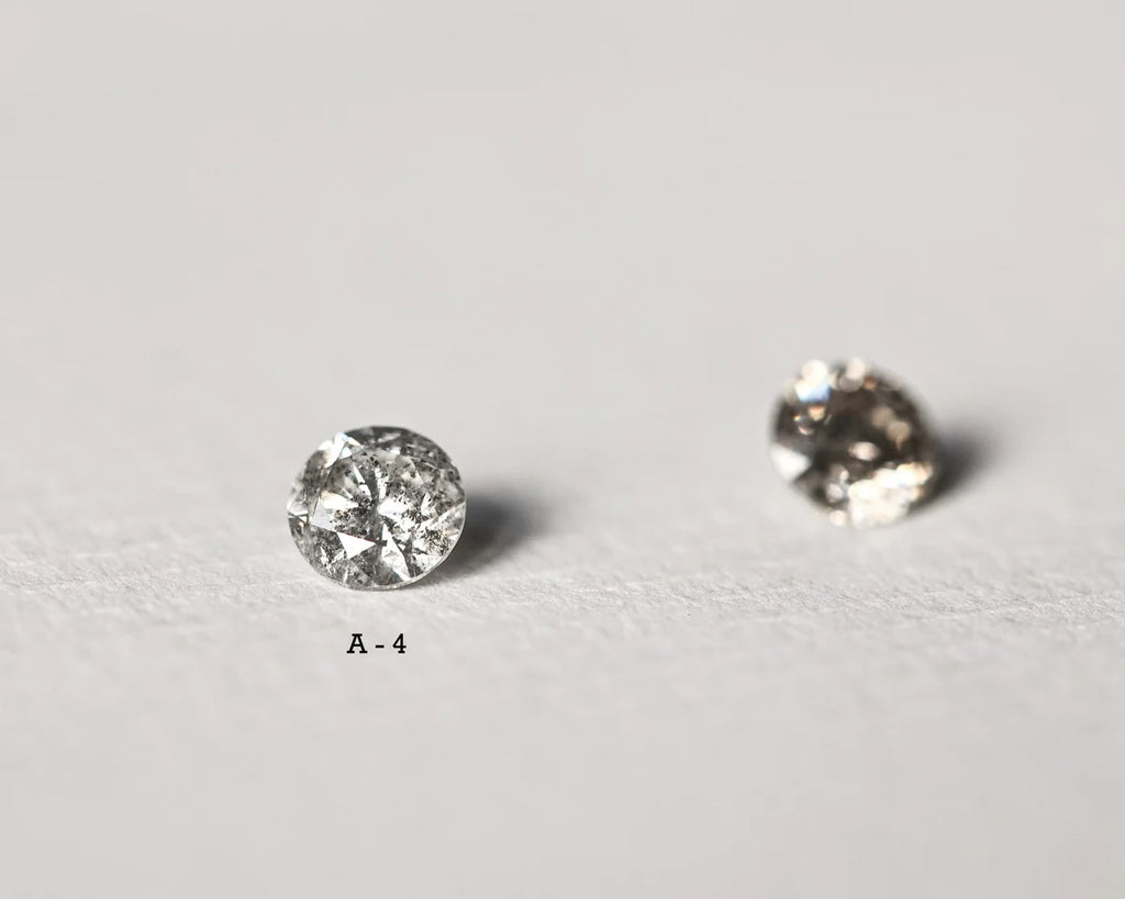 Two round diamonds on a light gray background