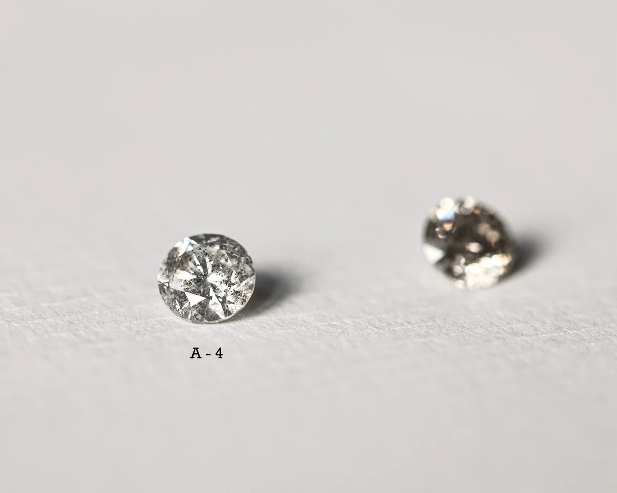 Two round diamonds on a light gray background
