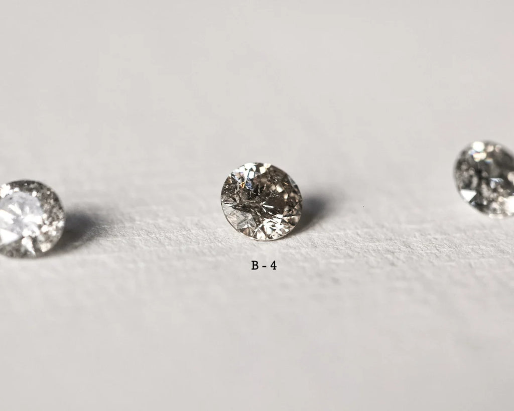 Three round diamonds on a light gray background